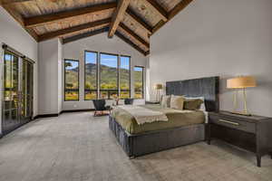 Bedroom featuring beam ceiling, high vaulted ceiling, a mountain view, light colored carpet, and wood ceiling