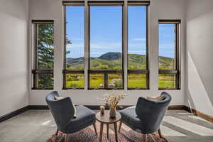 Living area with a mountain view and carpet floors