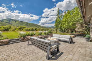 View of patio / terrace featuring a mountain view and an outdoor fire pit