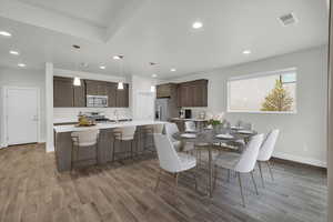 Dining room with hardwood / wood-style floors and sink