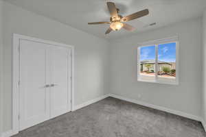 Unfurnished bedroom with light carpet, a closet, and ceiling fan