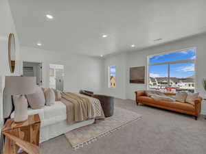 Primary Bedroom with light colored carpet, baseboards, visible vents, and recessed lighting