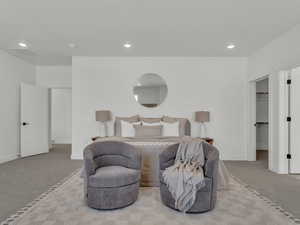 Primary Bedroom featuring a walk in closet, baseboards, carpet flooring, and recessed lighting