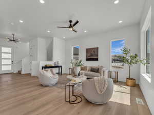 Living area featuring a wealth of natural light, light wood finished floors, visible vents, and recessed lighting