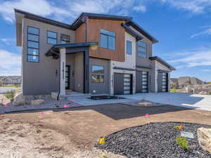 Contemporary house featuring a garage and concrete driveway