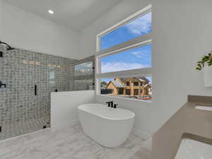 Primary Bathroom featuring a shower stall, a sink, marble finish floor, a freestanding bath, and recessed lighting