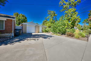 View of property exterior with an outdoor structure and a garage