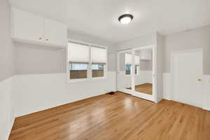 Unfurnished bedroom featuring light hardwood / wood-style flooring and a closet