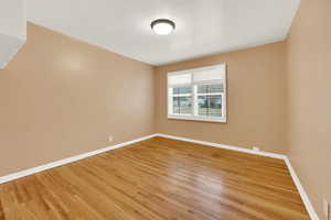 Spare room with hardwood / wood-style floors