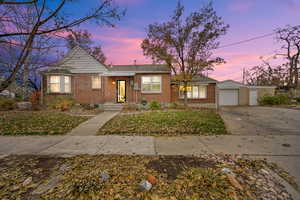 View of front of house featuring a garage and an outdoor structure