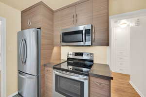 Kitchen with stainless steel appliances and light hardwood / wood-style floors