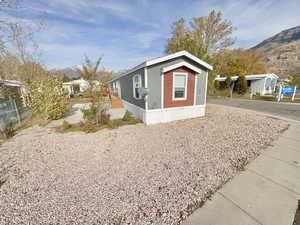 View of side of home with a mountain view