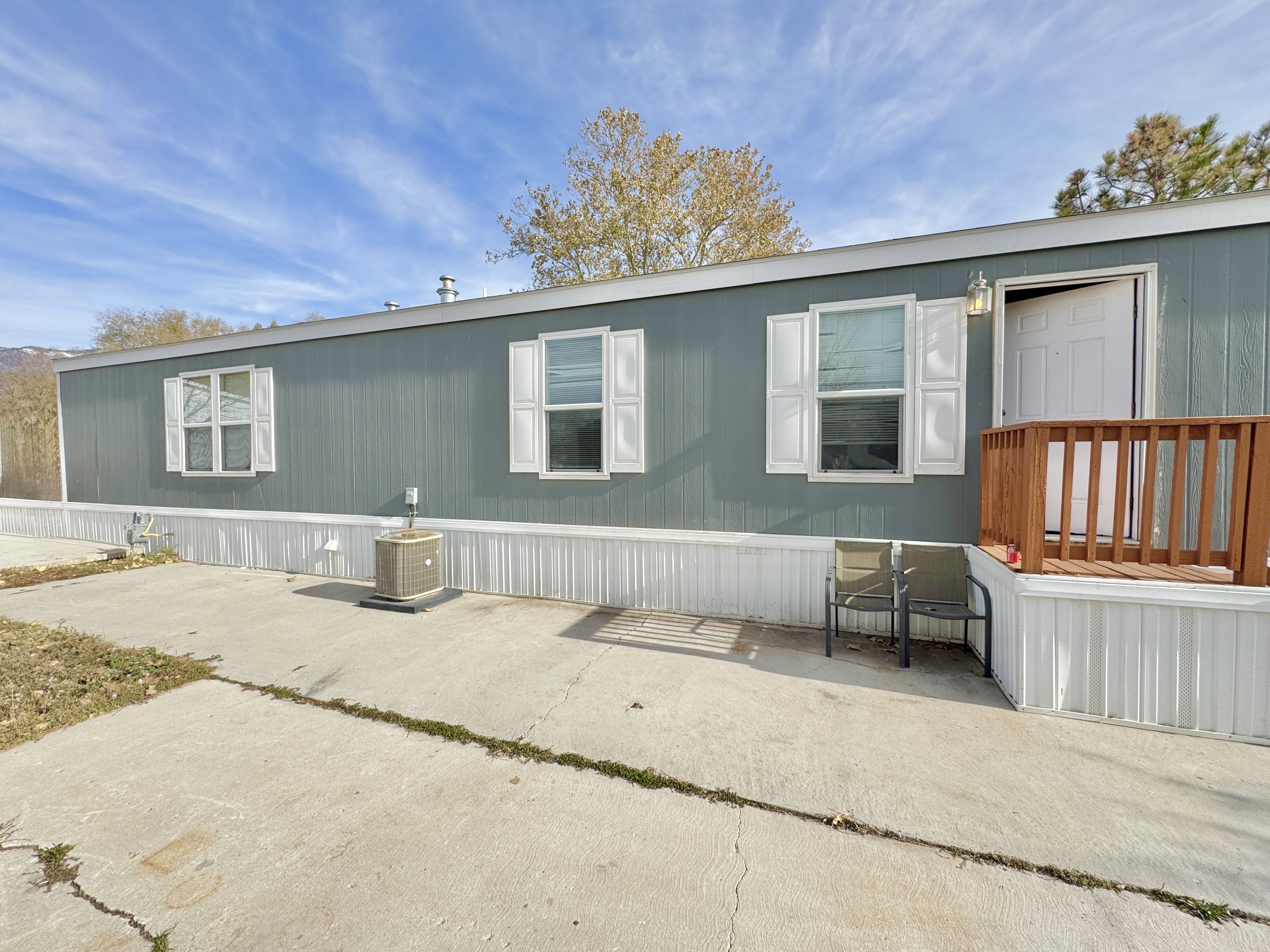 View of front of house featuring a patio area and central air condition unit