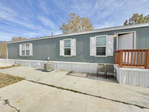 View of front of house featuring a patio area and central air condition unit