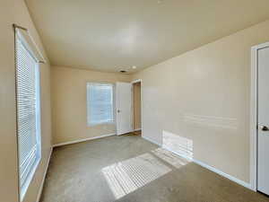 Unfurnished bedroom featuring light colored carpet