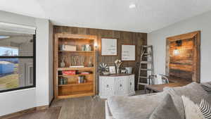 Interior space with wood walls and a textured ceiling