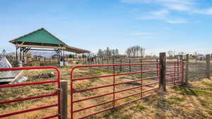 View of gate with a rural view