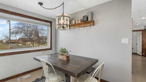 Tiled dining space with an inviting chandelier