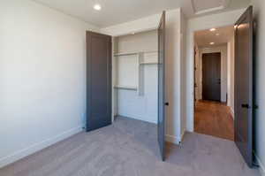 Unfurnished bedroom featuring a closet and carpet floors