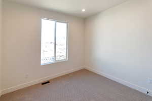 Spare room with carpet flooring and a healthy amount of sunlight