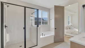 Bathroom with tile patterned flooring, vanity, and plus walk in shower