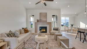 Living room featuring ceiling fan and light hardwood / wood-style flooring