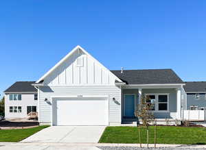 View of front facade with a garage and a front lawn