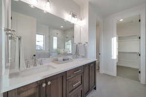 Bathroom with a shower with door, vanity, and toilet