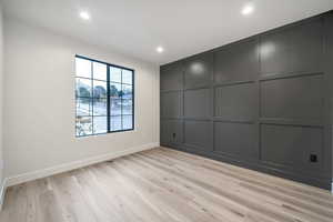 Unfurnished room with light hardwood / wood-style floors