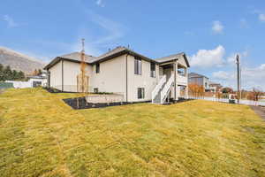 Rear view of property featuring a lawn