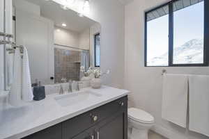 Bathroom featuring a mountain view, vanity, and toilet