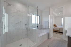 Bathroom featuring tile patterned flooring and separate shower and tub