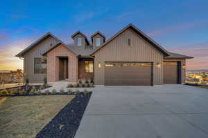 View of front of house featuring a garage and a lawn