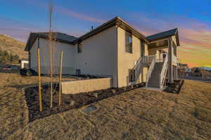 Property exterior at dusk featuring a lawn