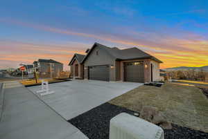 Property exterior at dusk with a mountain view and a garage