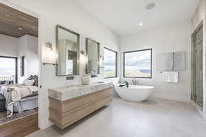 Bathroom featuring shower with separate bathtub, vanity, and hardwood / wood-style flooring