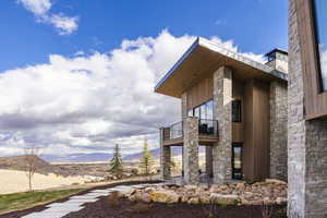 View of home's exterior featuring a mountain view and a balcony