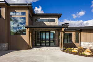 Doorway to property featuring a patio area