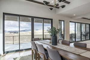 Dining room featuring a mountain view, plenty of natural light, and a chandelier