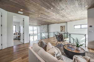 Living room featuring wooden ceiling and hardwood / wood-style flooring