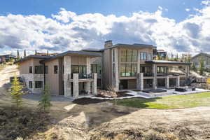 Rear view of house featuring a patio area and a balcony