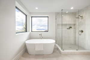 Bathroom with tile patterned floors and separate shower and tub