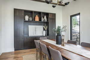 Dining area featuring light hardwood / wood-style floors and an inviting chandelier