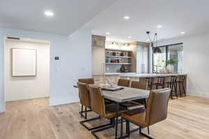 Dining space with light hardwood / wood-style flooring