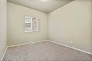 Spare room featuring light colored carpet