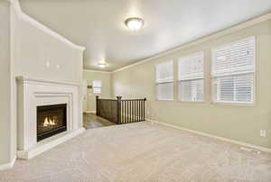 Interior space featuring carpet flooring and crown molding