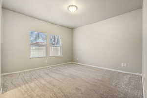 Unfurnished room featuring light carpet