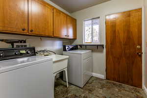 Laundry area with cabinets and independent washer and dryer