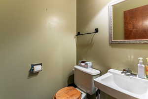 main floor half Bathroom with sink and toilet