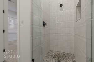 Bathroom featuring tiled shower